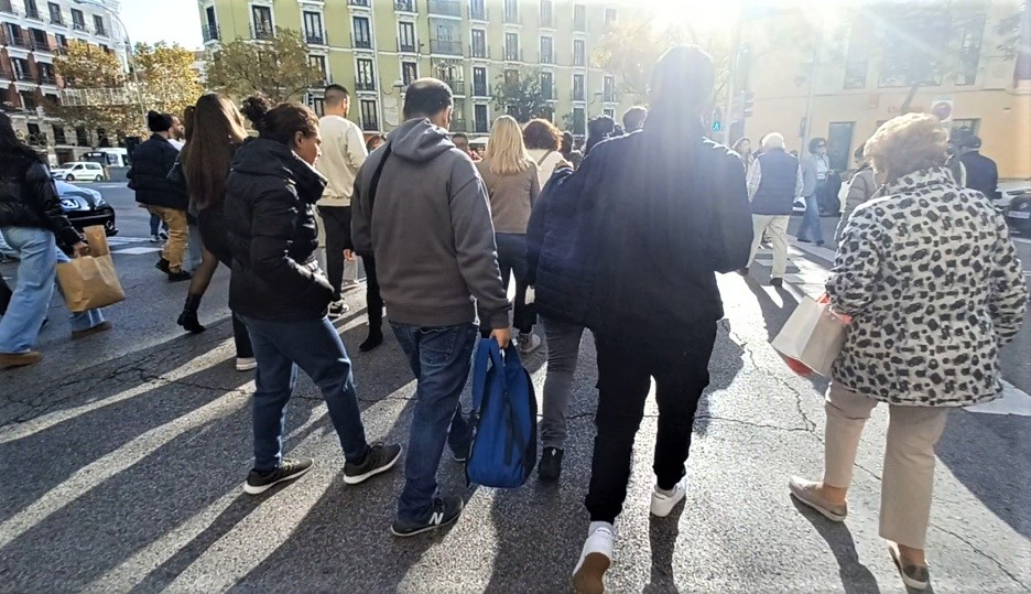 Población cruzando un semáforo en una calle de Madrid.